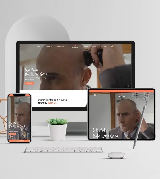 Responsive Website Design Display Man shaving head shown on various devices