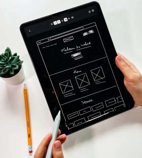 Website Wireframe on Tablet Tablet displaying a wireframe design for a website.