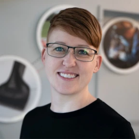 Testimonial from Ada Deacon on project success Photo of Ada Deacon from Trimax Mowers sharing her experience working with EvinceDev on customer service mobile app spare part.